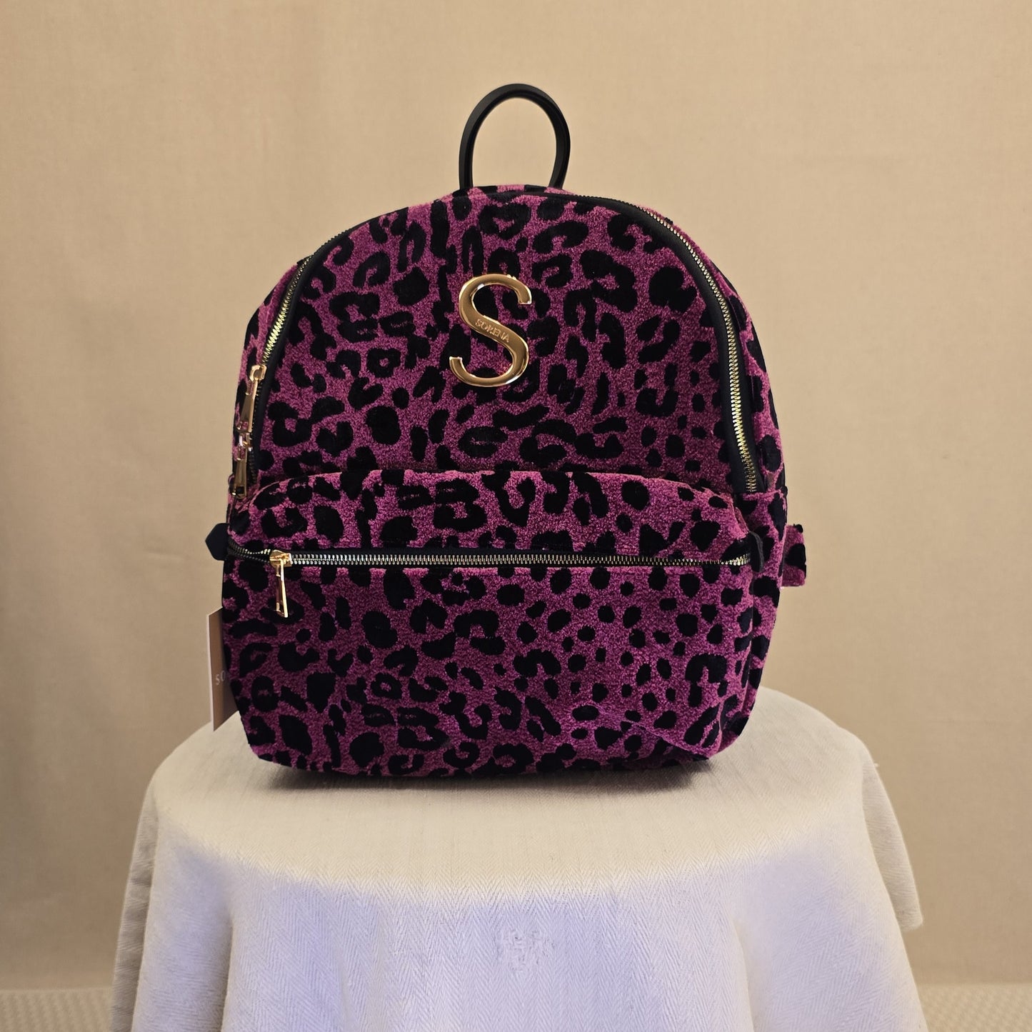 Sorena Backpack in Magenta mit schwarzem Leopardenmuster, goldenem S-Logo und Frontfach mit Reißverschluss.