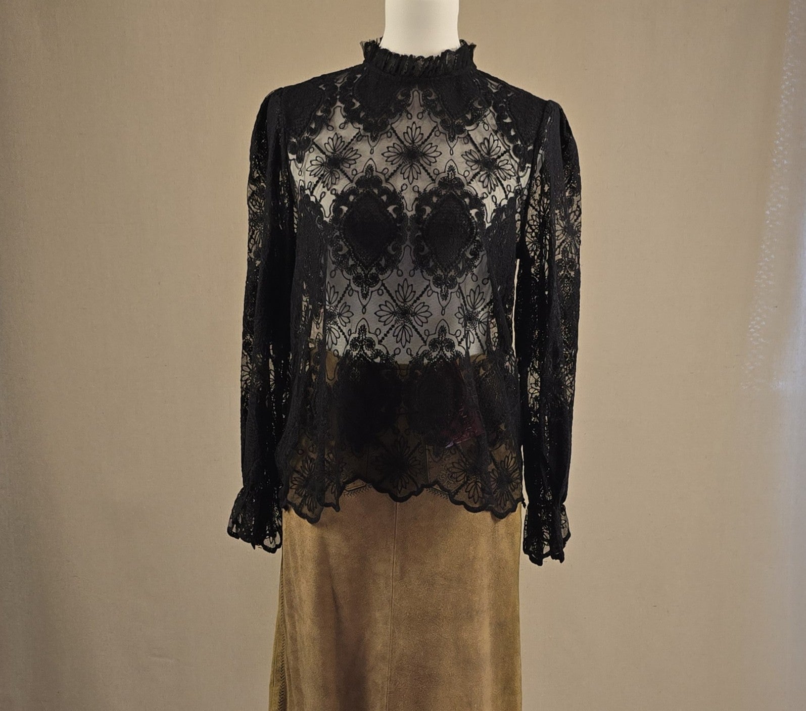 Schwarze Spitzenbluse mit Stehkragen, vorne getragen zum Echtleder-Trachtenrock, elegante Kombination.