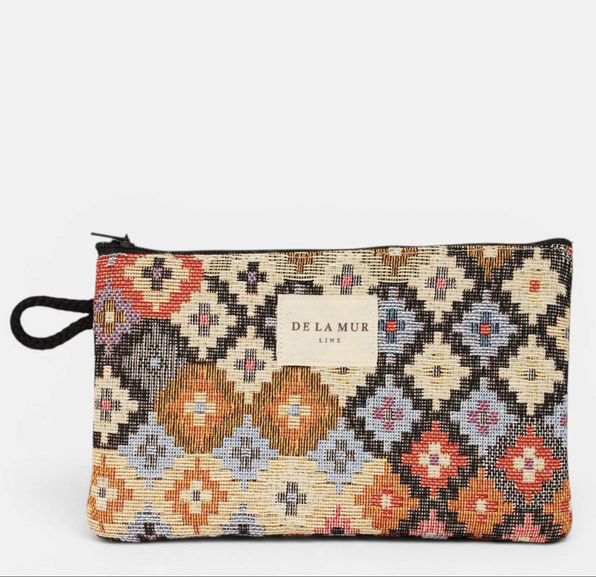 Mini-Kosmetiktasche Ore von De La Mur mit mehrfarbigem geometrischem Jacquardmuster und schwarzer Seitenschlaufe
